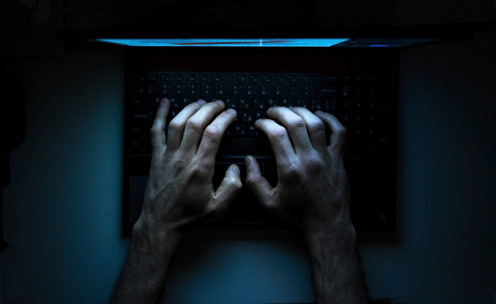 Top view of the hands of a MOGO User on laptop